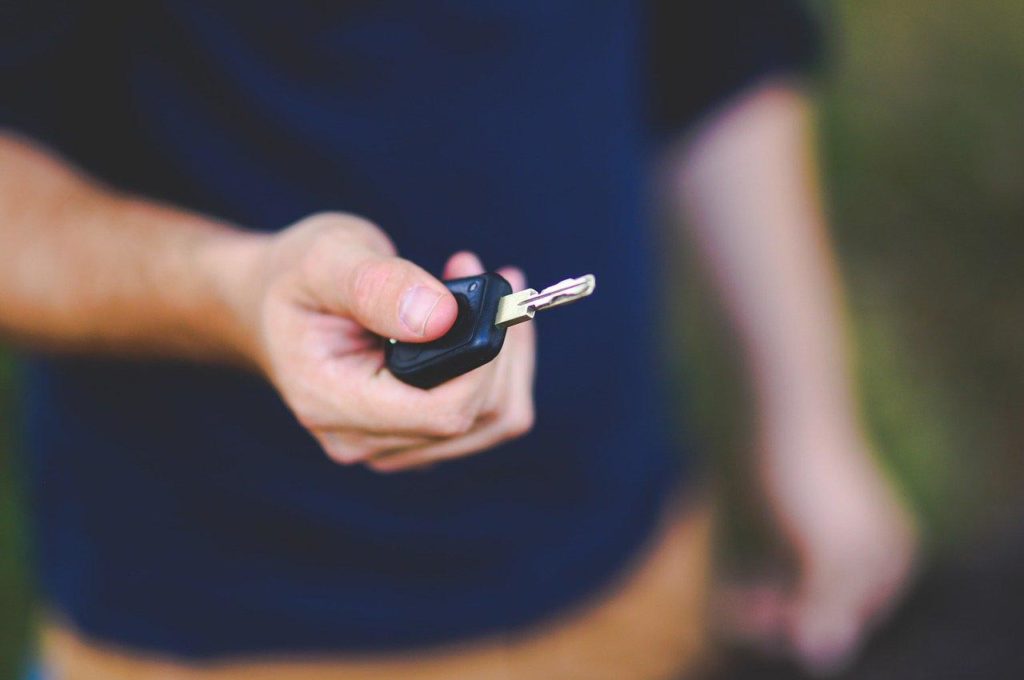 A man holding a car key.